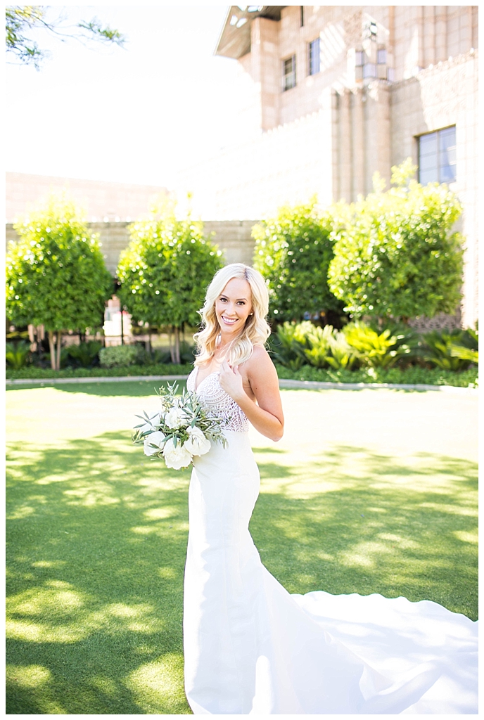 Bride in two piece wedding dress with white floral and greenery wedding bouquet