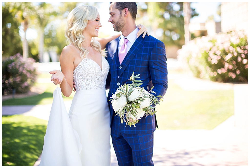 bride in two piece wedding dress and groom in custom blue suit 