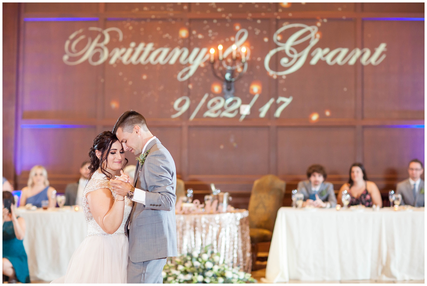 Bride and Groom dancing their fist dance with name in lights behind them