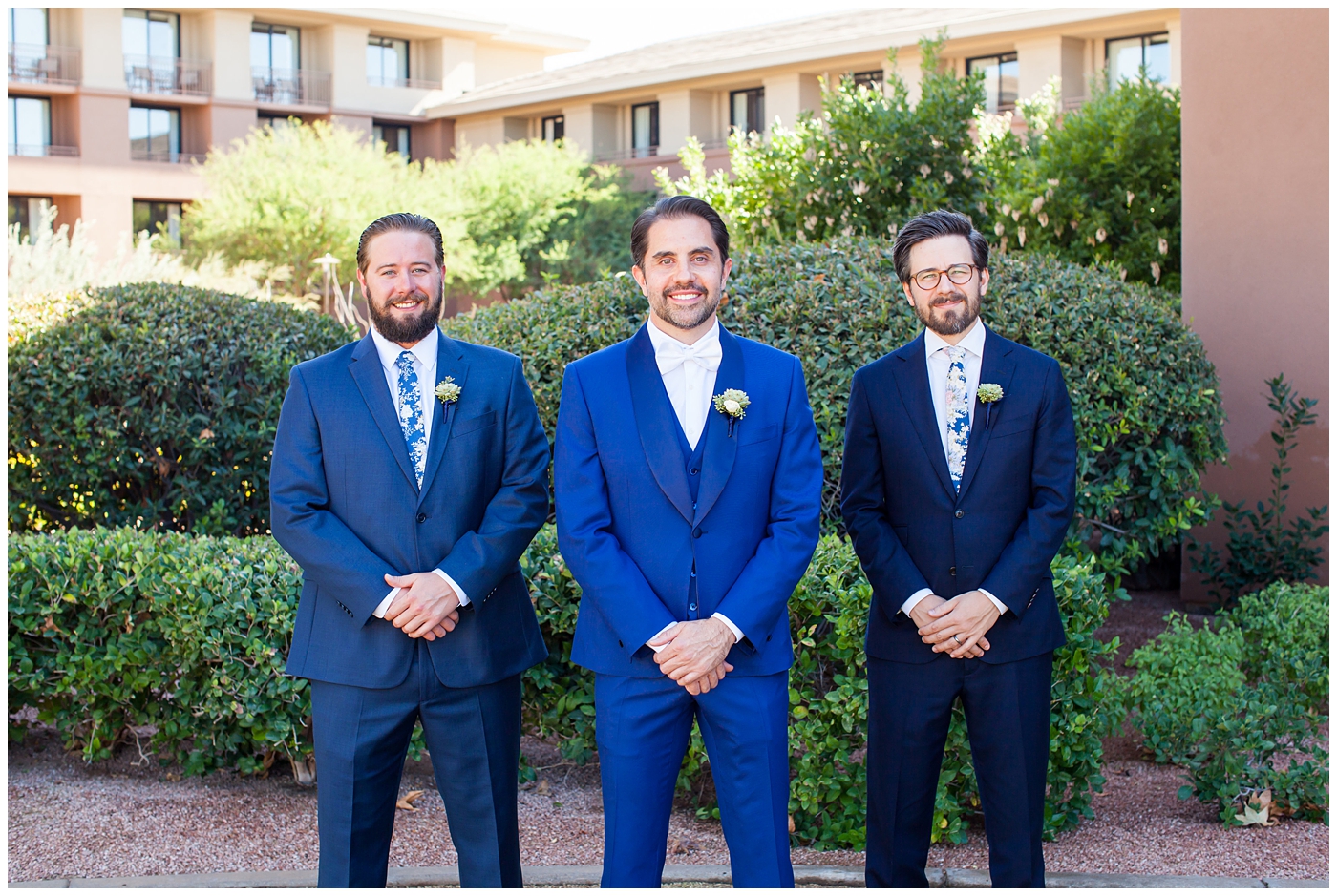 Groom in a custom Brother's Tailors Blue suit with groomsmen