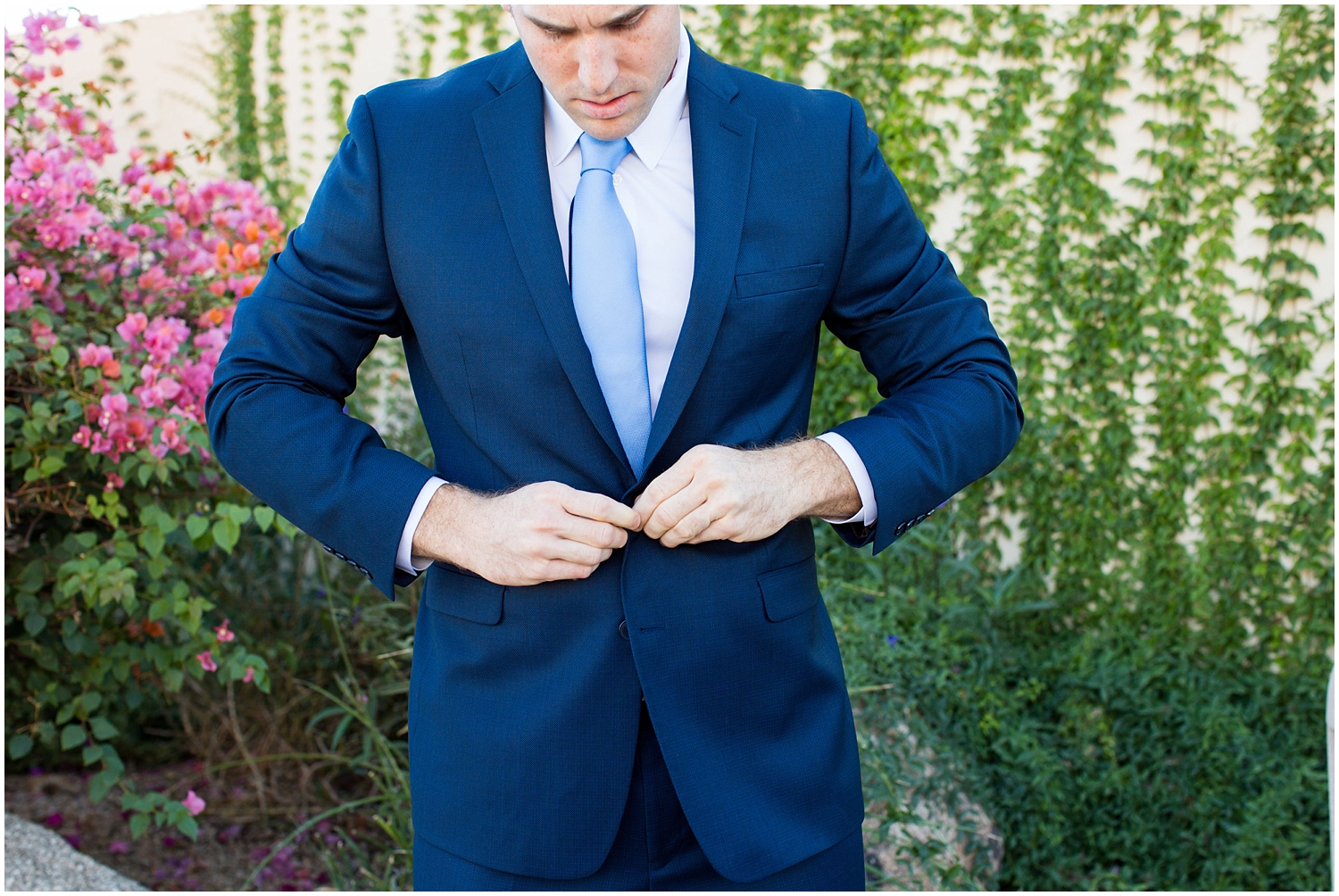 groom getting ready in blue suit