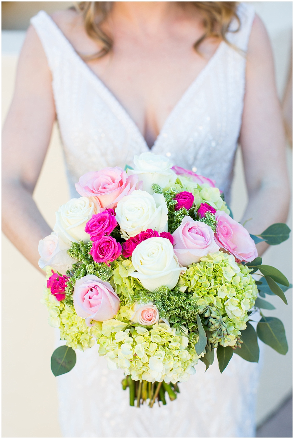 bride wedding bouquet with white, bright and blush pink roses and greenery