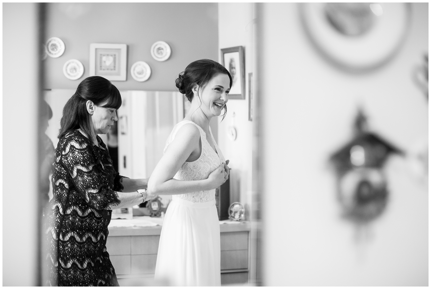 Bride getting ready in her room with her mother