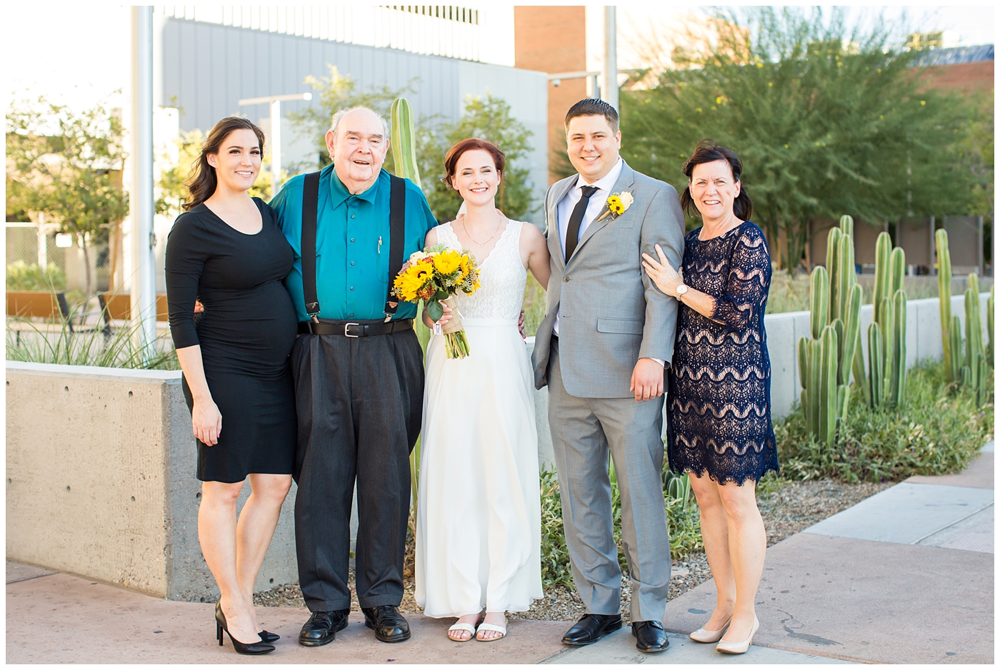 bride and groom with family portrait