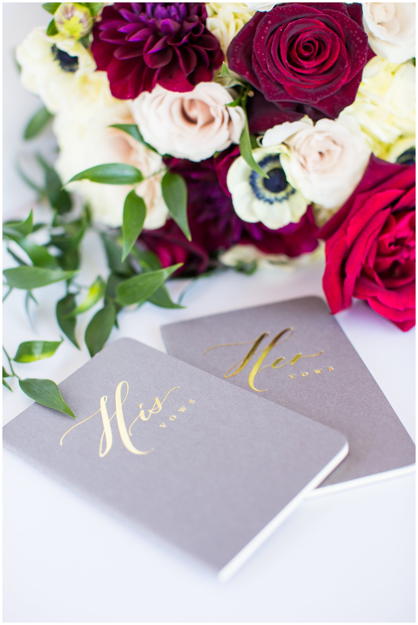 his and her gray booklets with gold lettering