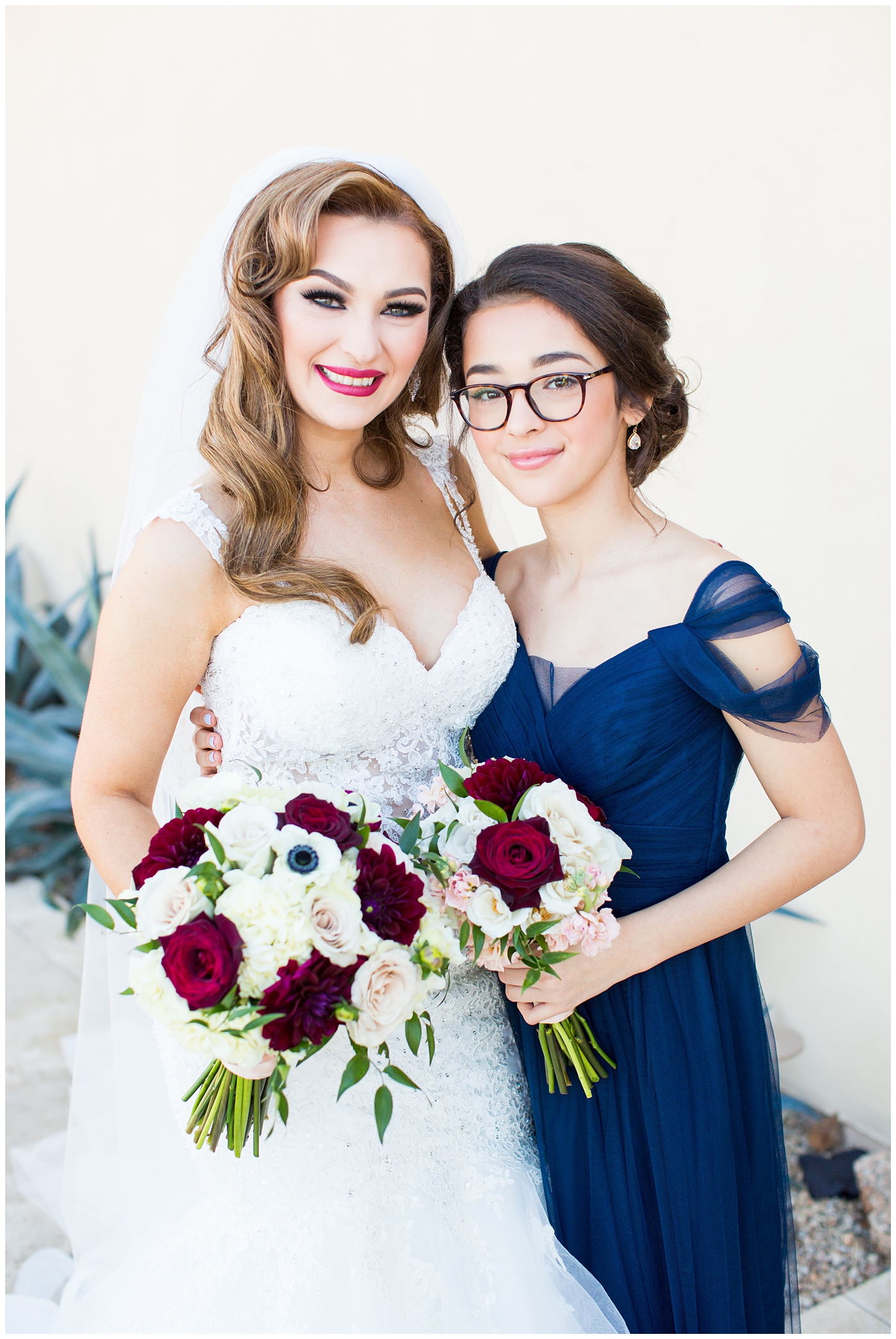 bridesmaids in blue dresses with bride in morilee wedding dress with red and white bouquet 