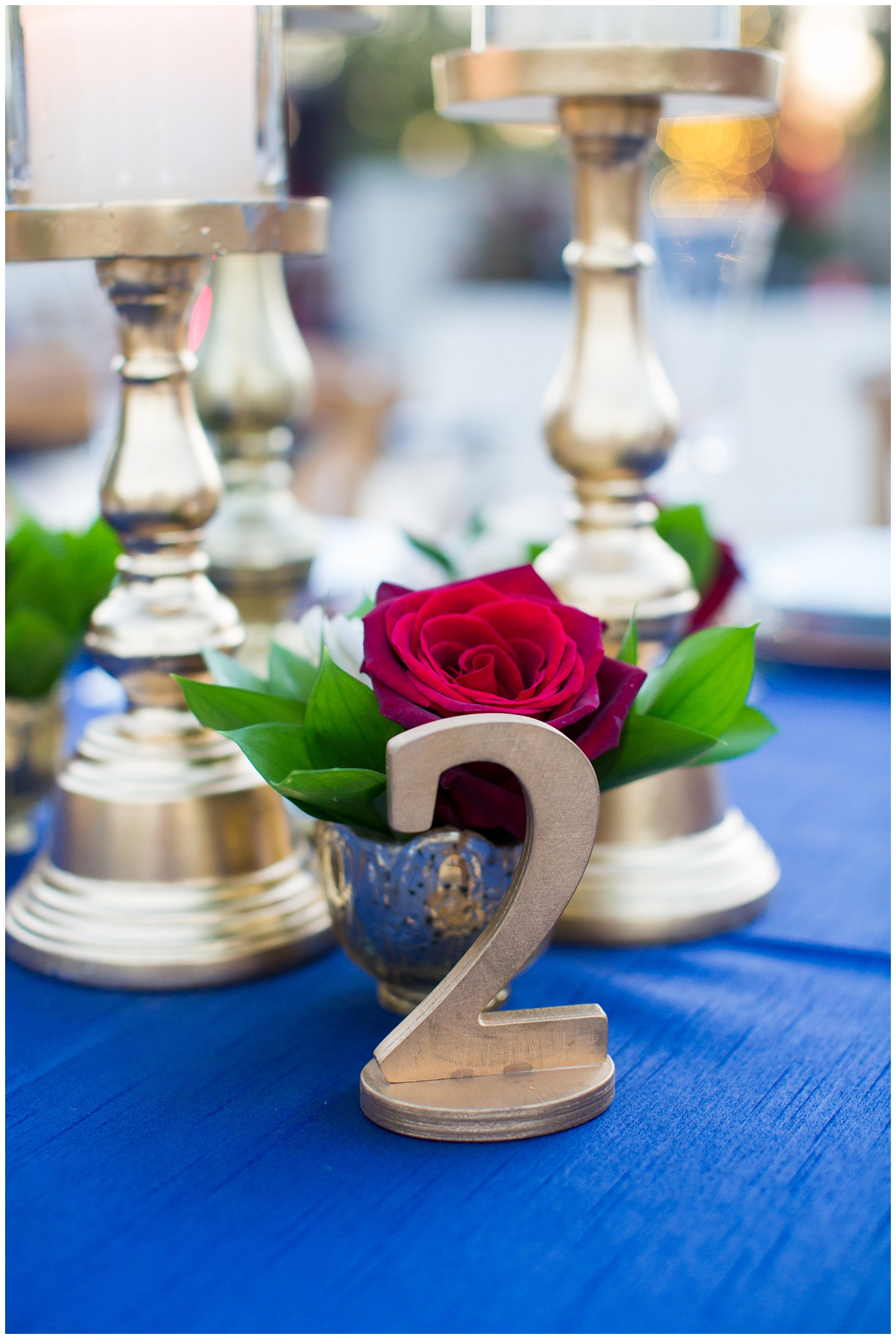 gold table number on blue linen