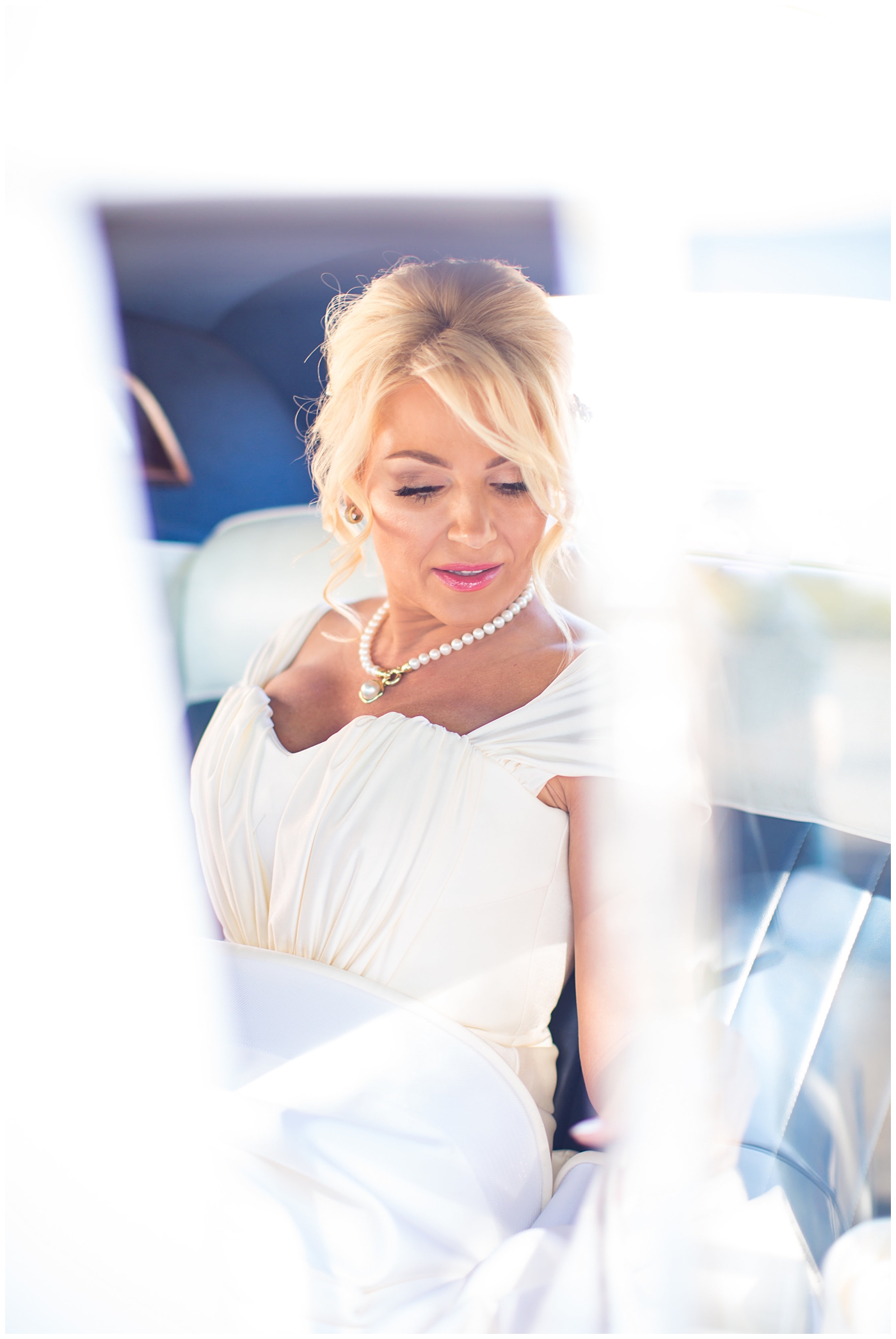 glamorous bride in cap sleeve wedding dress in car