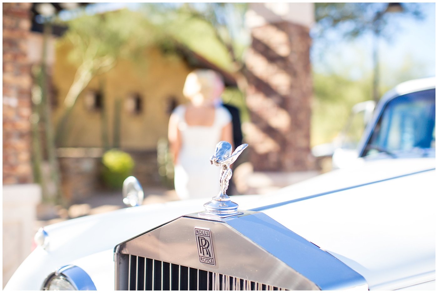 bride and groom first look by rolls royce