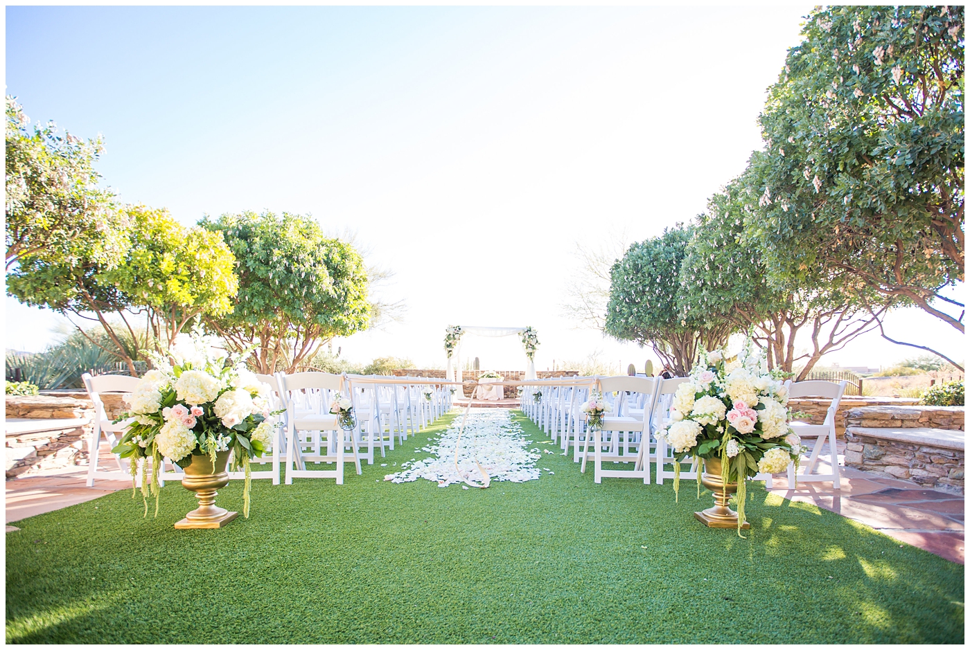 Sassi lawn ceremony site with rose petal aisle