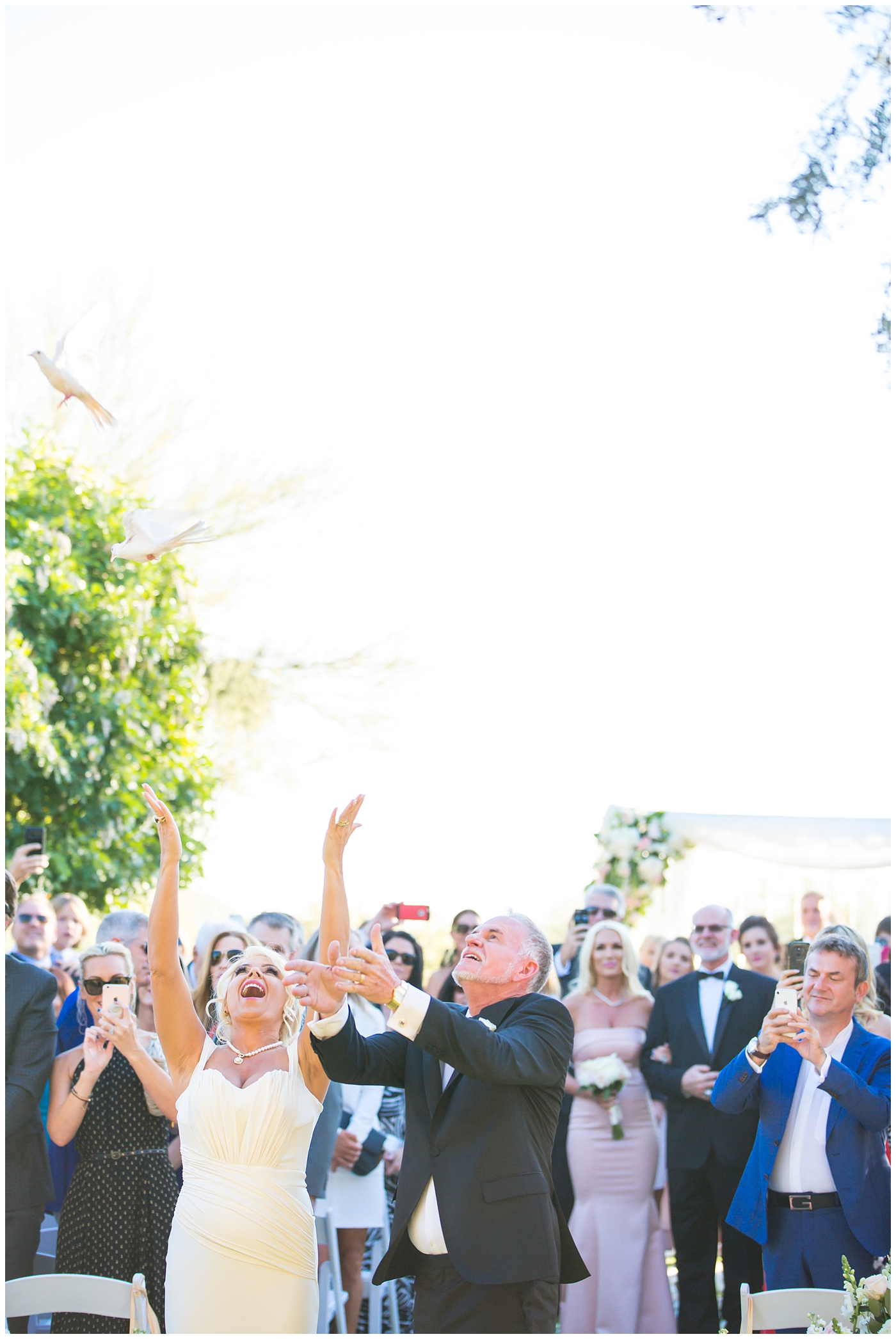 bride and groom releasing doves