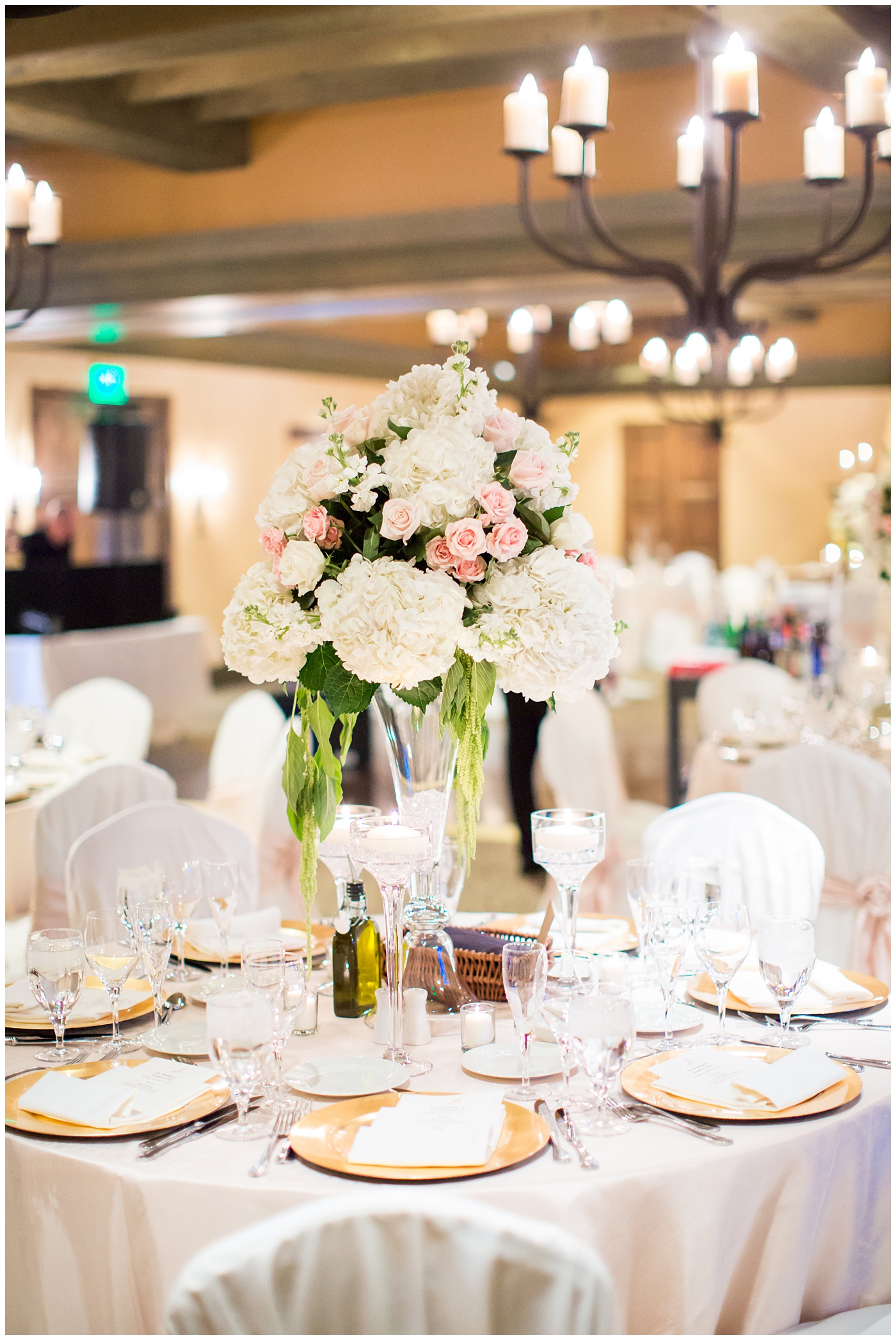 reception with white and pink flower arrangements with roses and gold