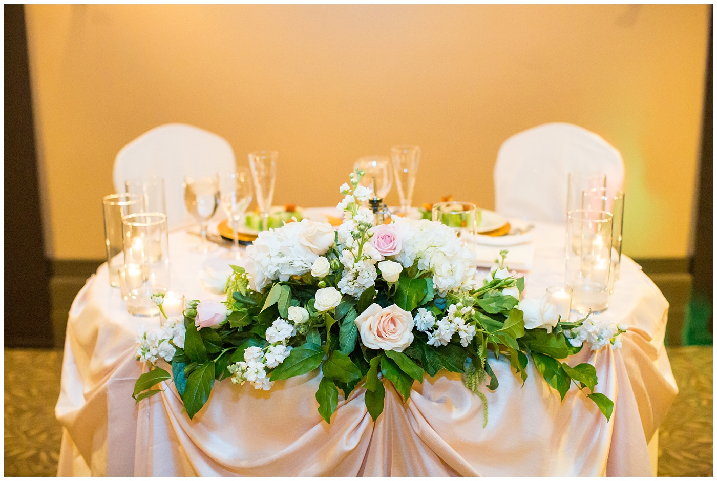 reception with white and pink flower arrangements with roses and gold