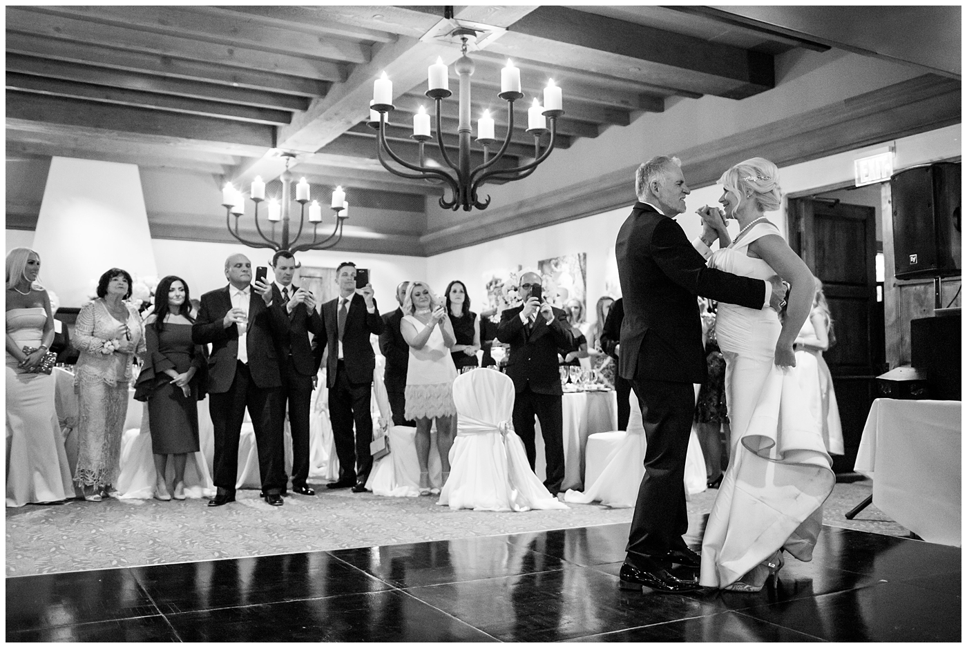 Bride in cap sleeve dress and groom in black tux first dance