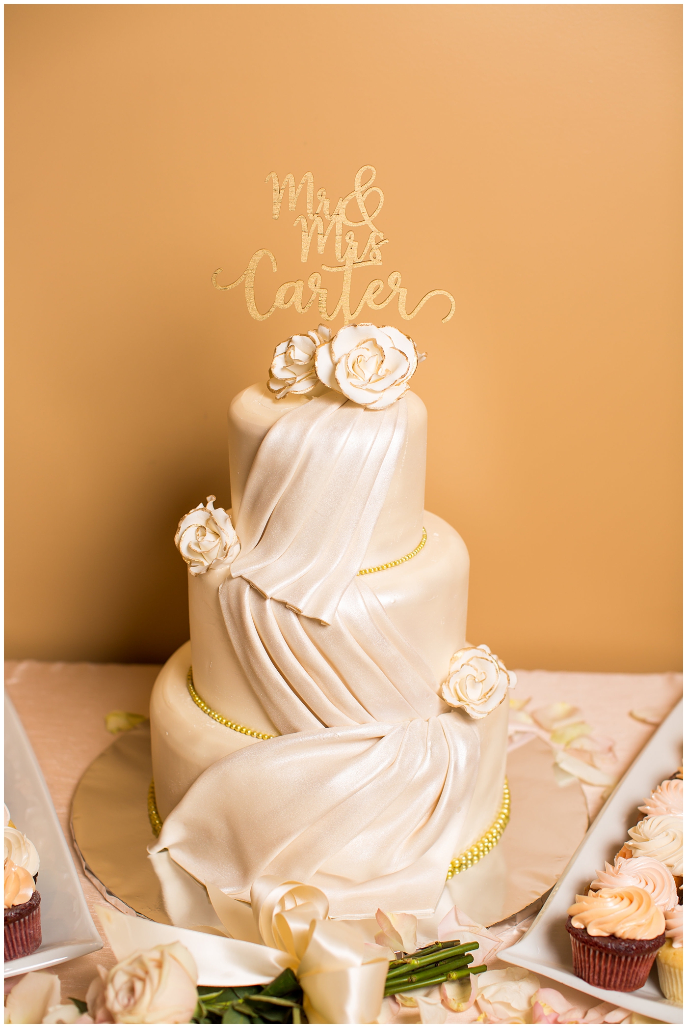 wedding cake with draped with fondant and flowers