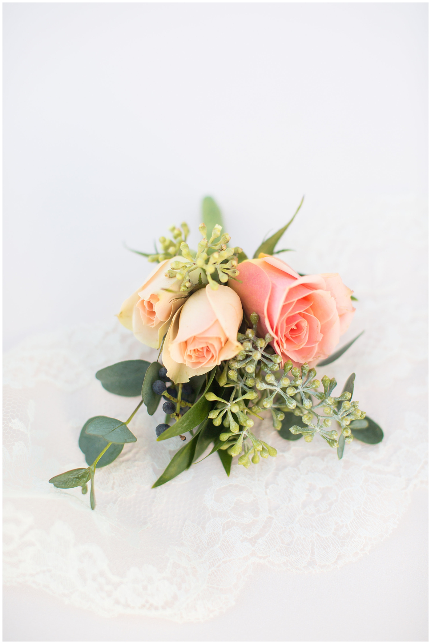 orange and pink blush rose with greenery boutonniere 