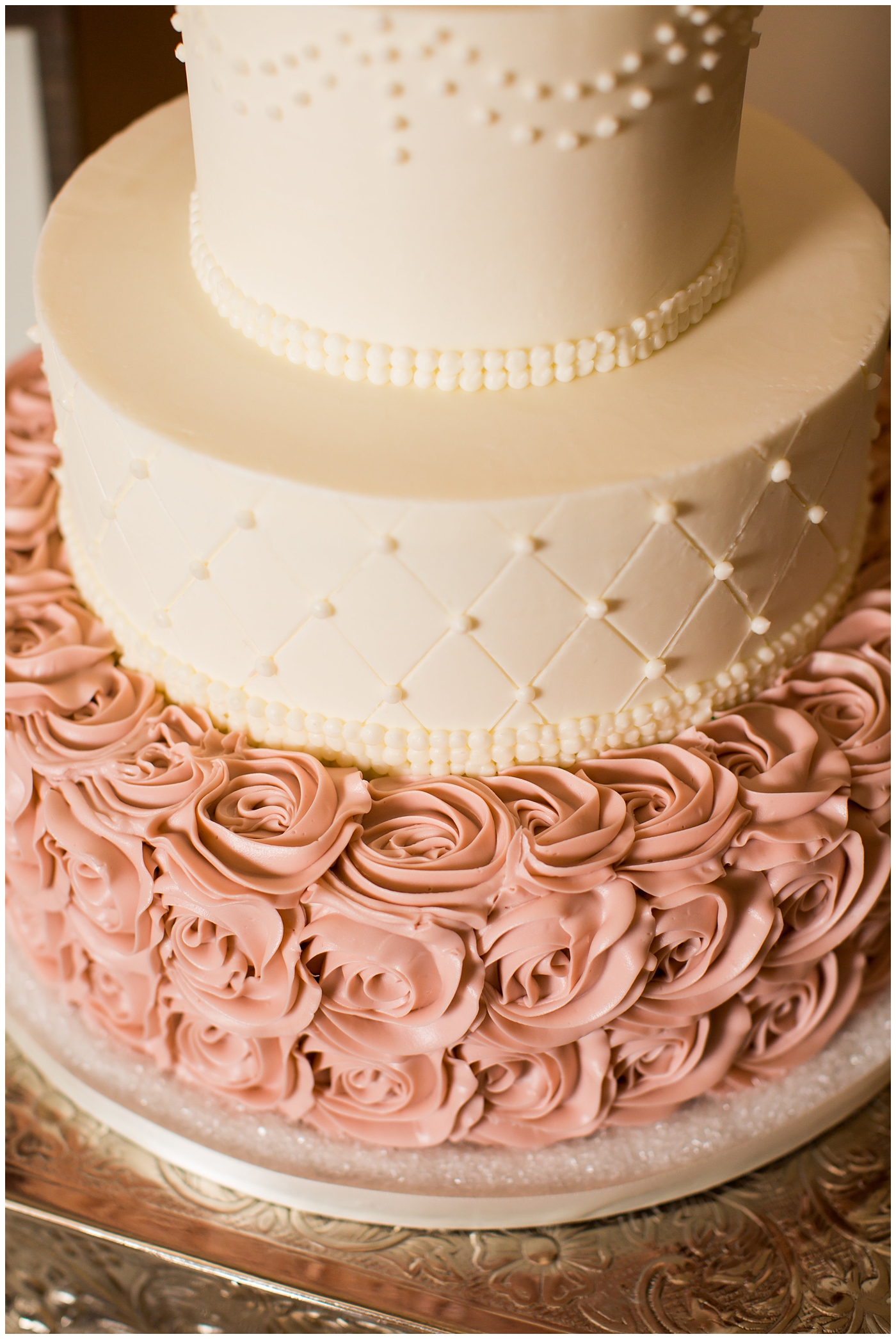 cream and white with pink frosting florals wedding cake with gold name cutout cake topper