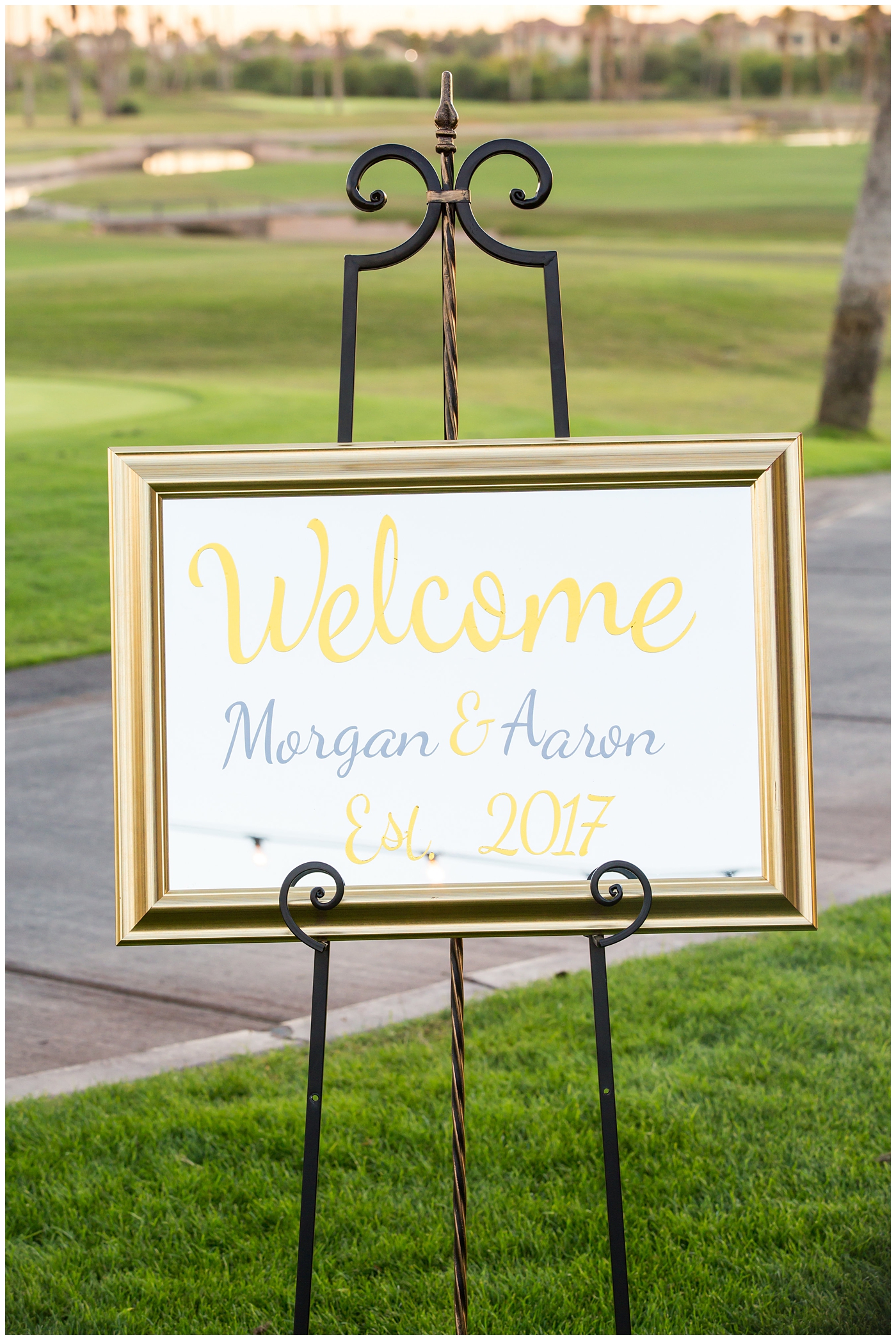 gold wedding welcome sign in a frame on easel