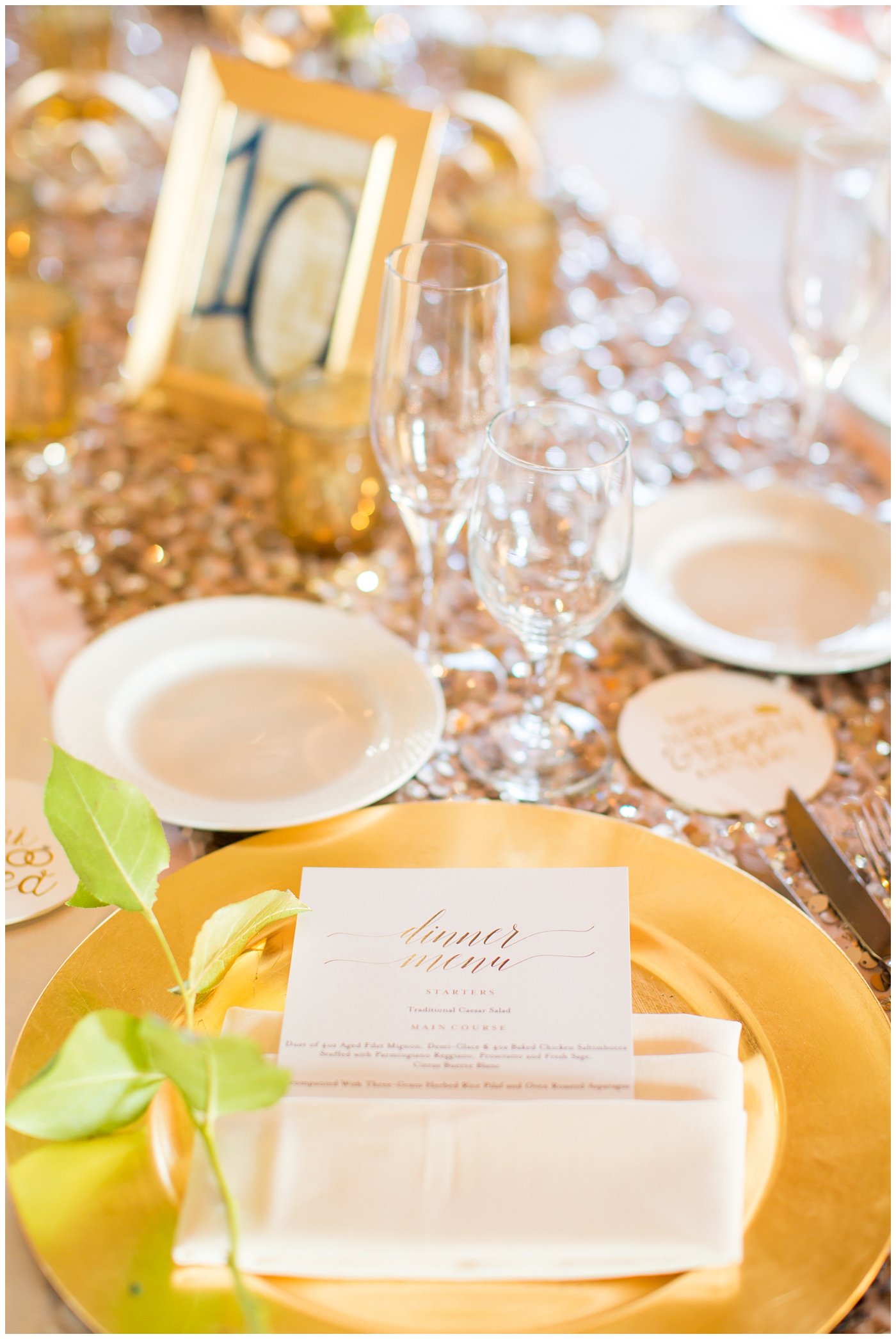 gold charger with ivory napkin on blush rose gold sequin linen for wedding reception