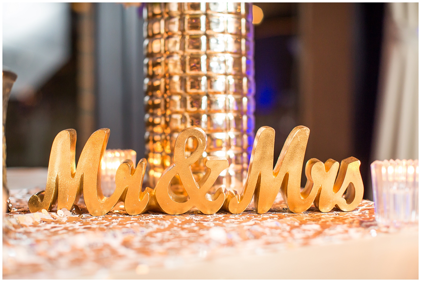 mr. and mrs. sign and gold vase with white roses on rose gold sequin linen for wedding reception