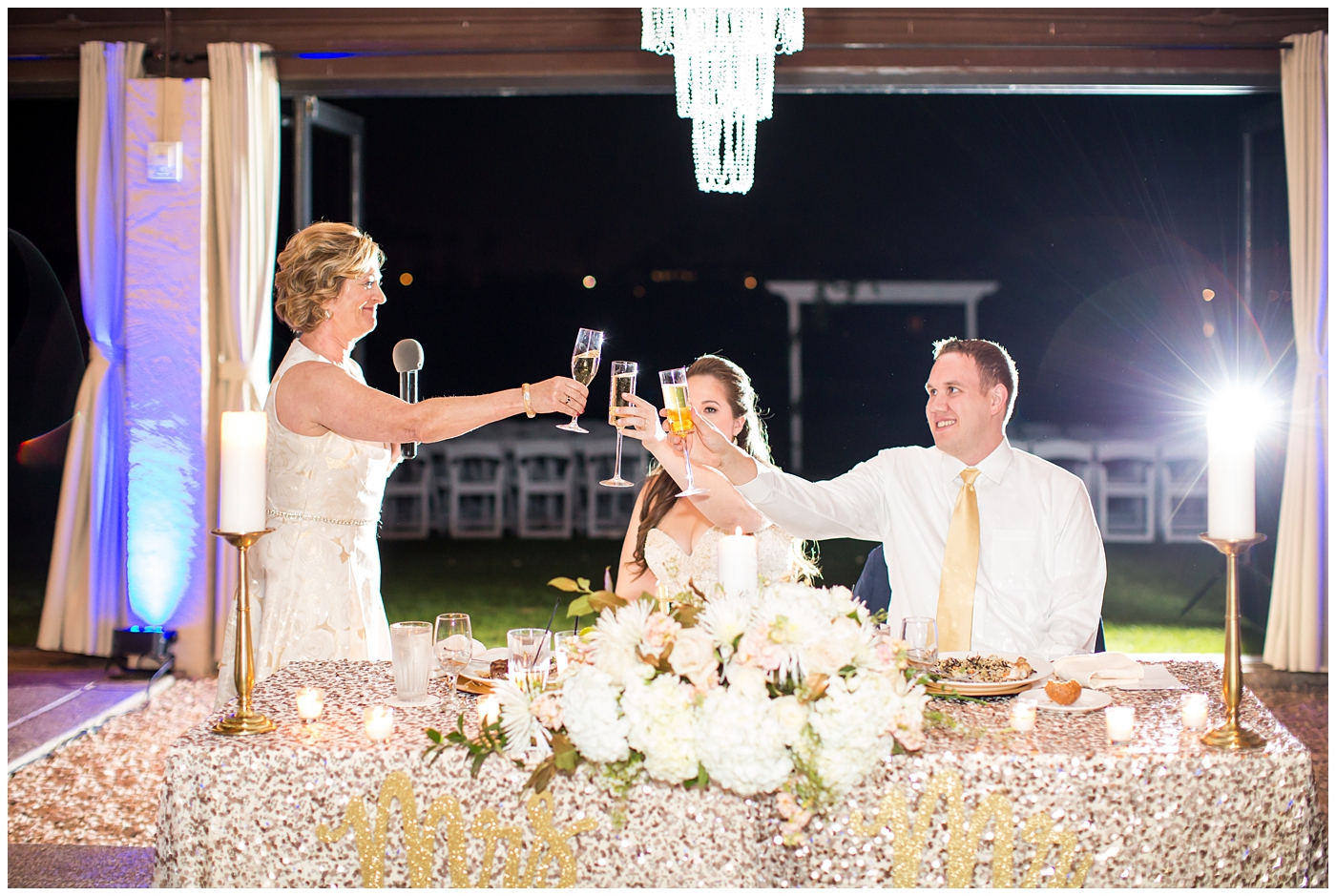 wedding toasts at reception to bride and groom in ballroom
