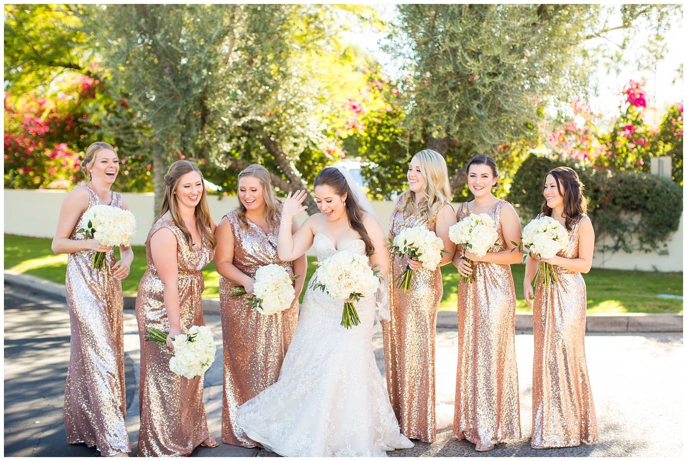 white rose wedding bouquet with bride in lillian lottie couture wedding dress and bridesmaids in rose gold sequin dress helping bride get ready
