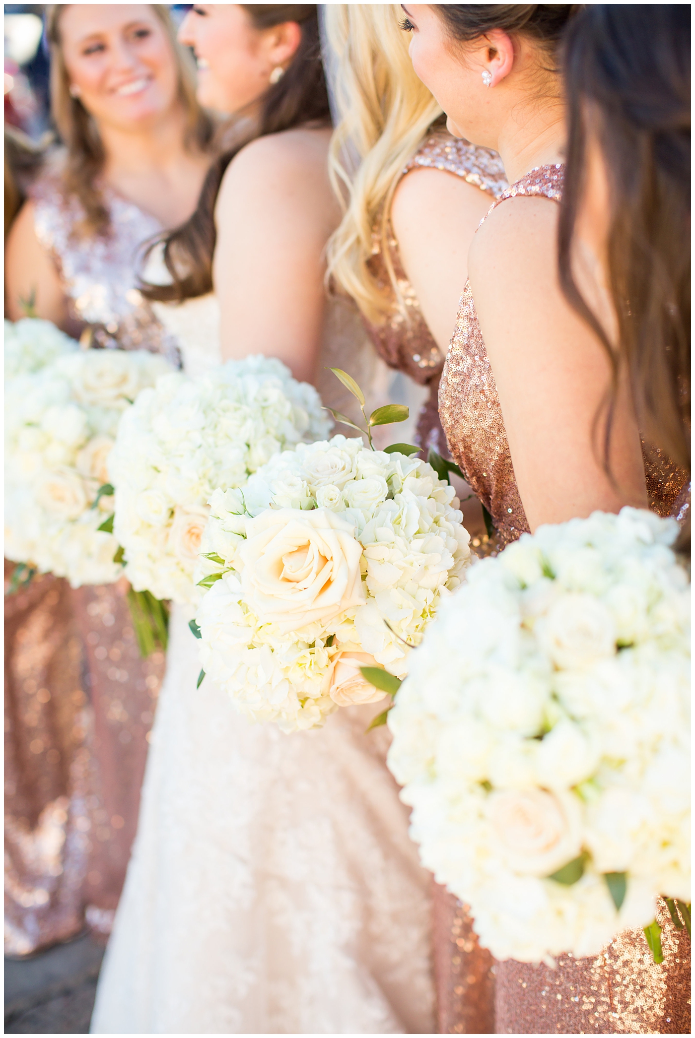 white rose wedding bouquet with bride in lillian lottie couture wedding dress and bridesmaids in rose gold sequin dress