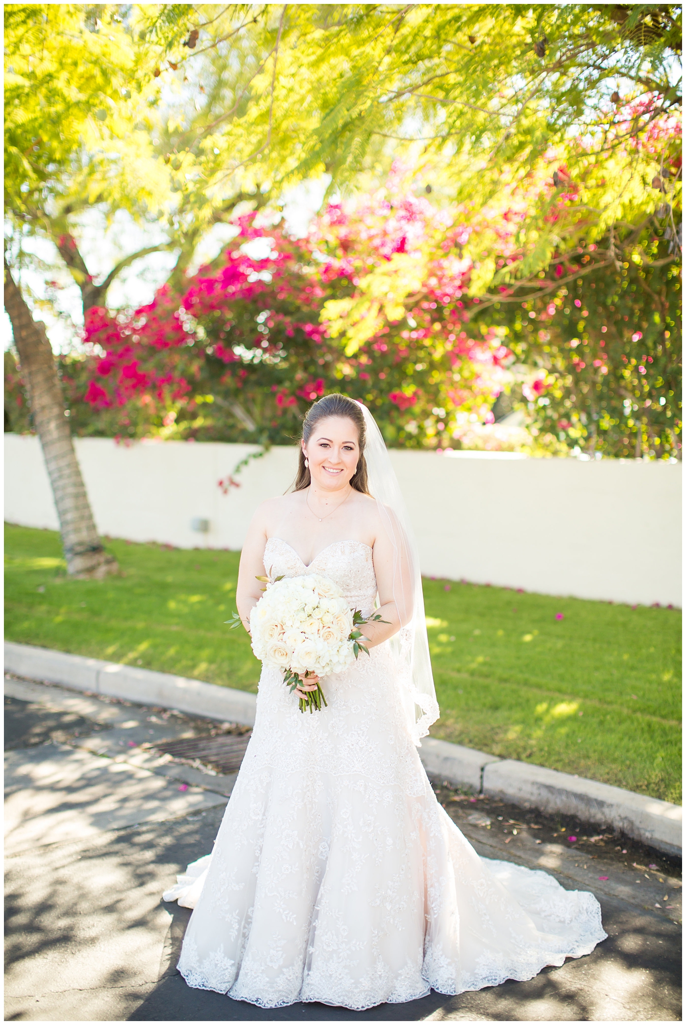 bride in lillian lottie couture wedding dress with white rose bouquet