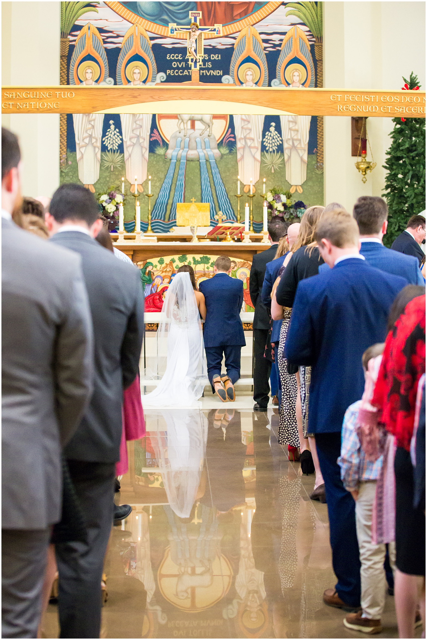 bride in demetrios bridal gown racerback with sheer beading with white hydrangeas bouquet with groom in navy blue suit with light blue tie in church wedding day