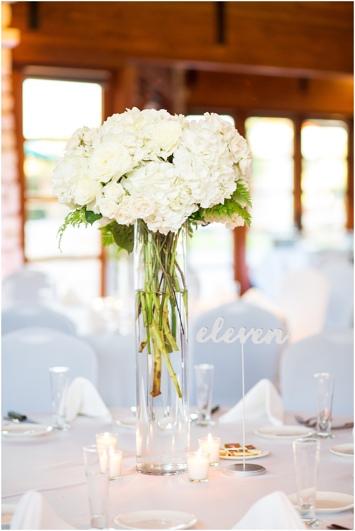 white hydrangeas and white table number wedding day reception details