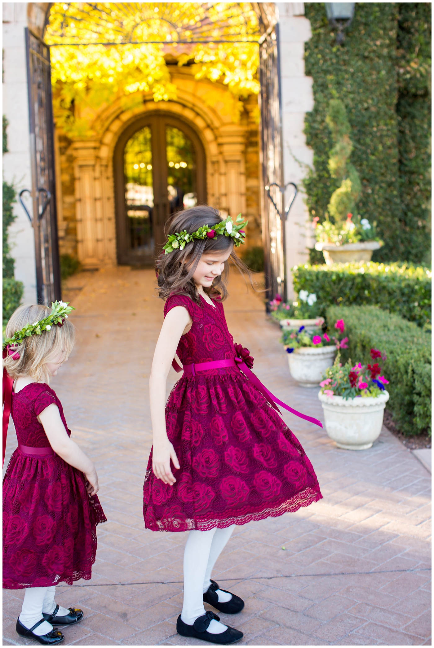wedding day portrait with flower girls with floral head bands and burgundy dresses at Villa Siena