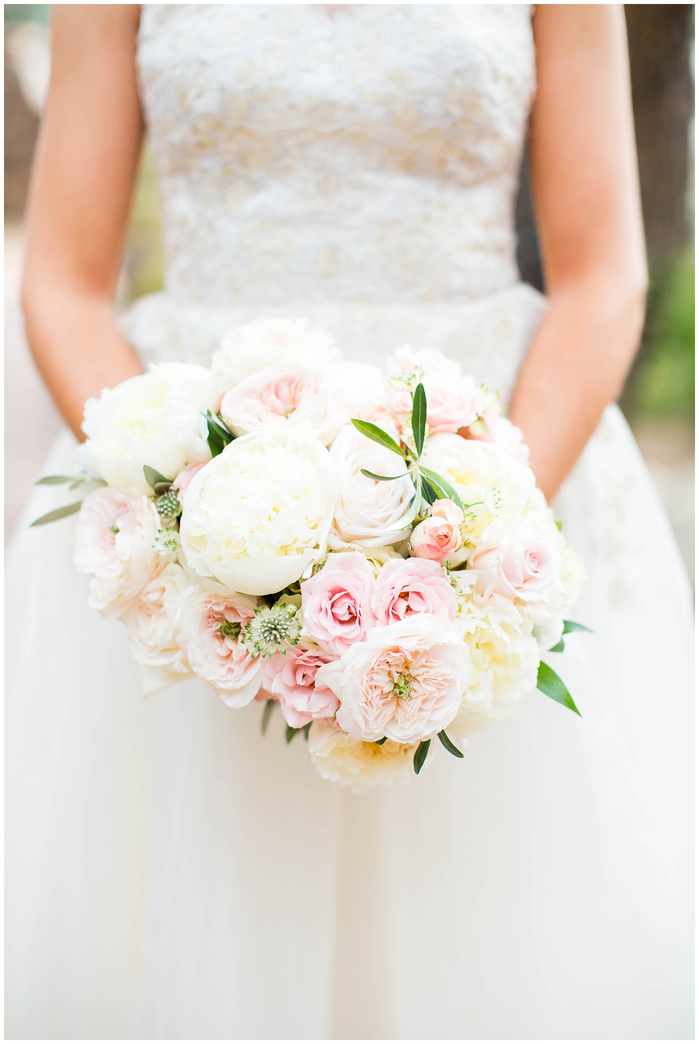 bride's flower bouquet with white and pink roses and greenery
