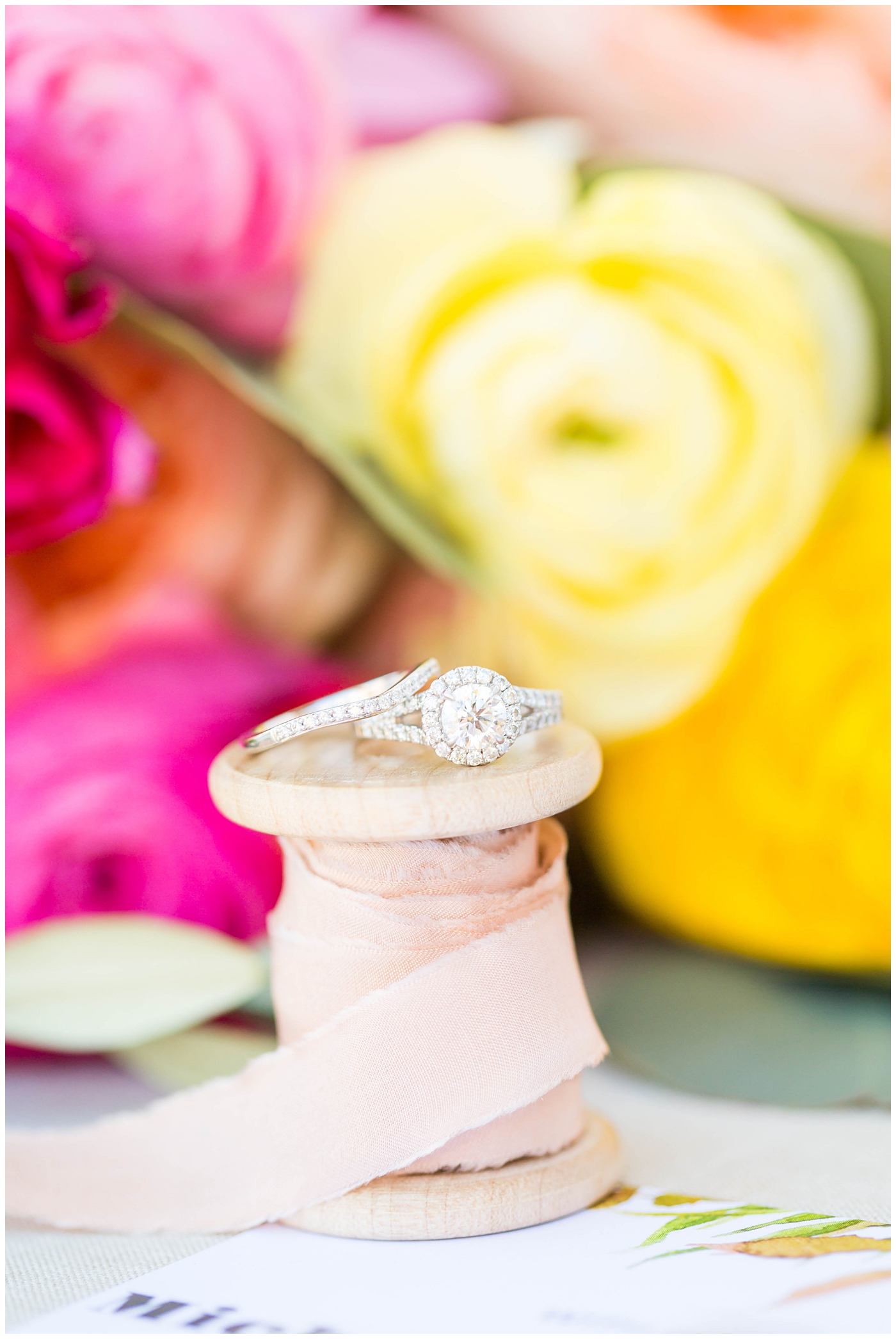 wedding ring in white mrs. box with bright floral wedding bouquet