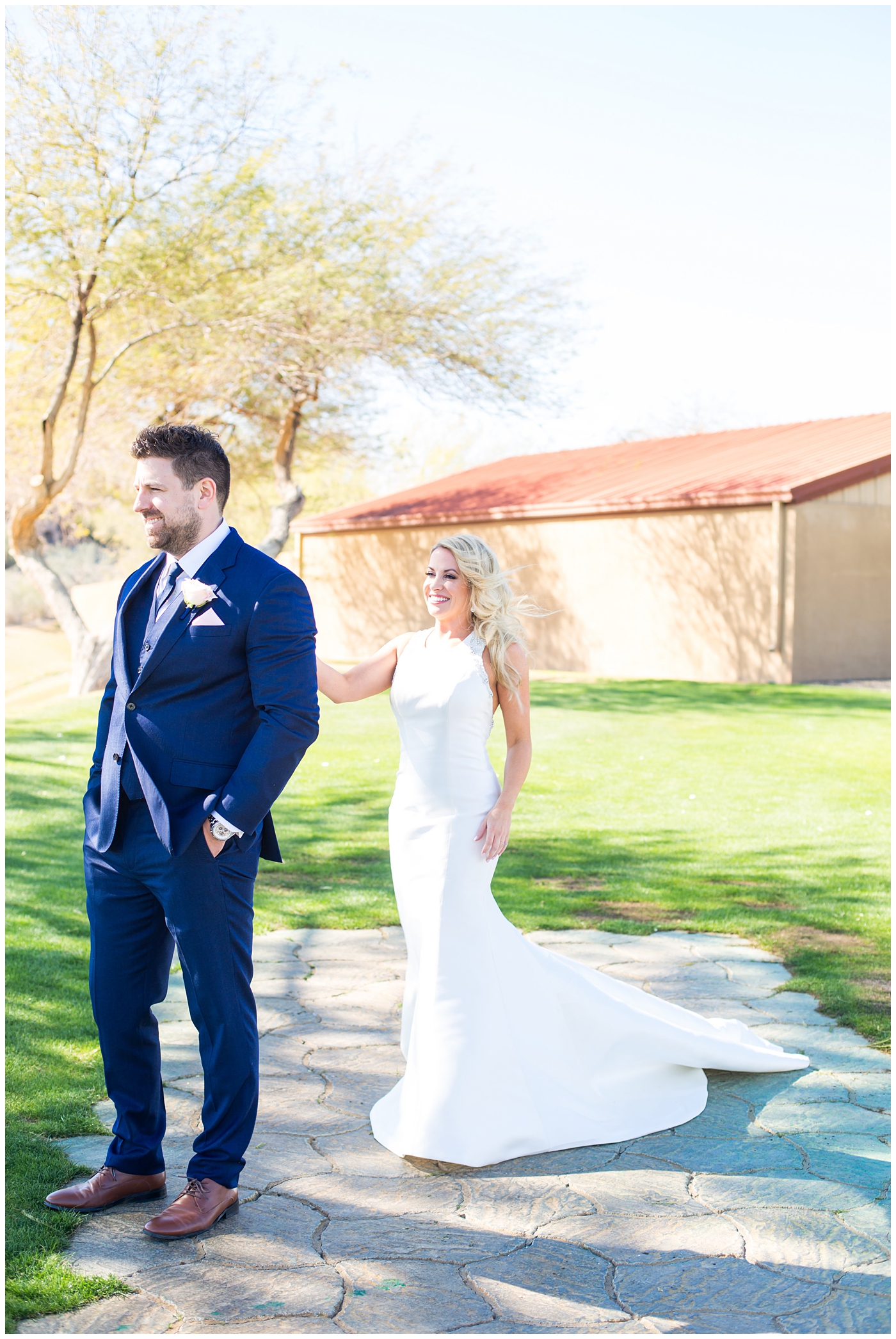 gorgeous bride with side swept hair in racerback pronovias with groom in navy suit and tie first look on wedding day