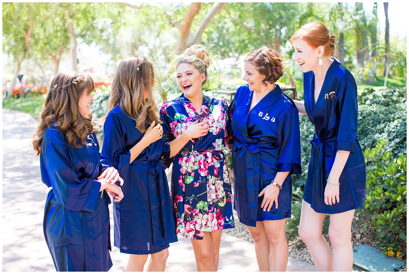 bride in custom blue floral robe with bridesmaids in blue robes getting ready pictures