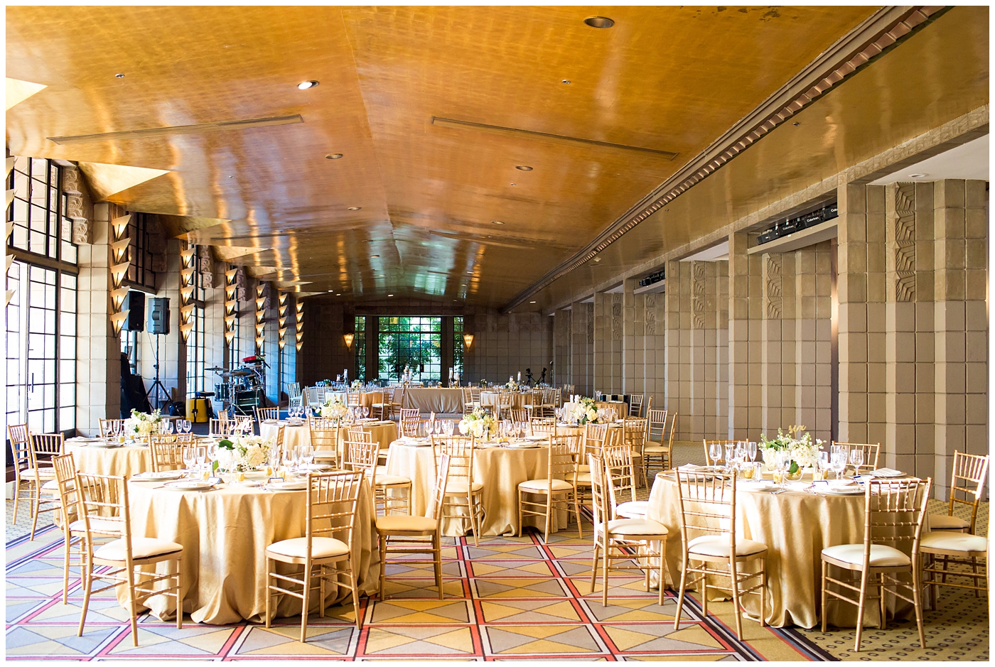 Arizona Biltmore gold ballroom wedding reception details with gold chairs and tablecloths with white roses and greenery centerpieces in gold vases with glitter royal blue placecards