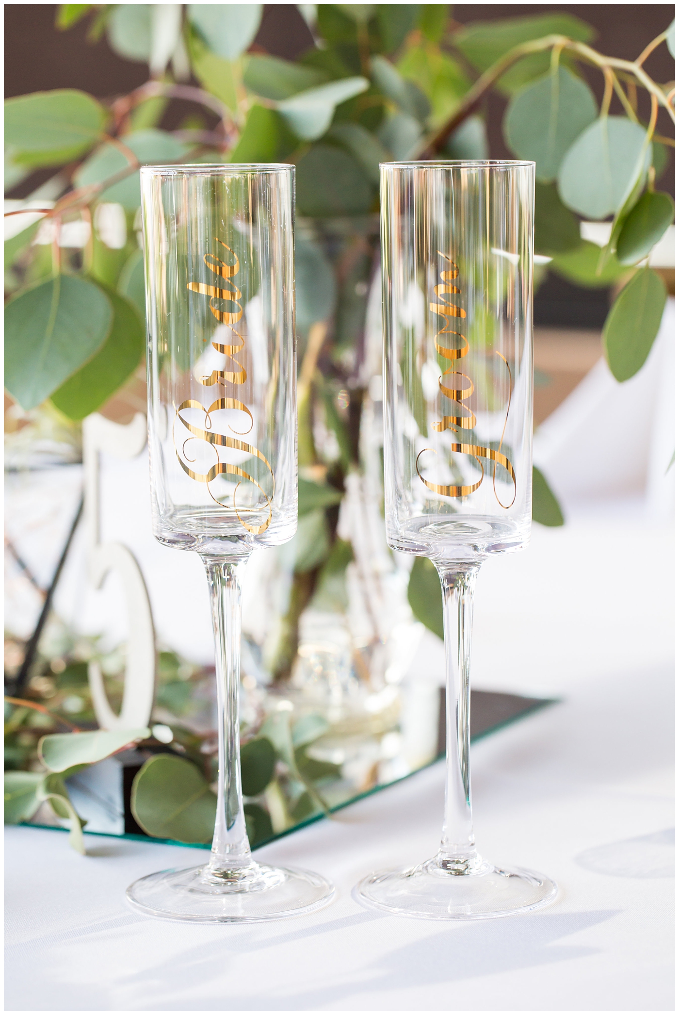 bride and groom champagne flutes with gold writing wedding day reception detail