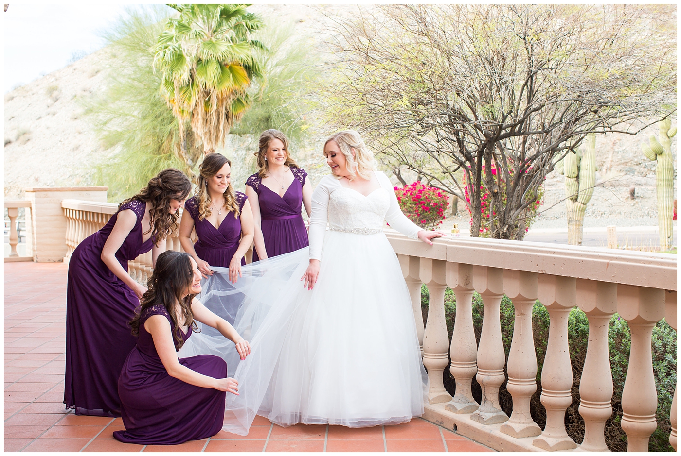 blonde bride in long sleeve wedding dress with bridesmaids in plum dresses getting ready on wedding day