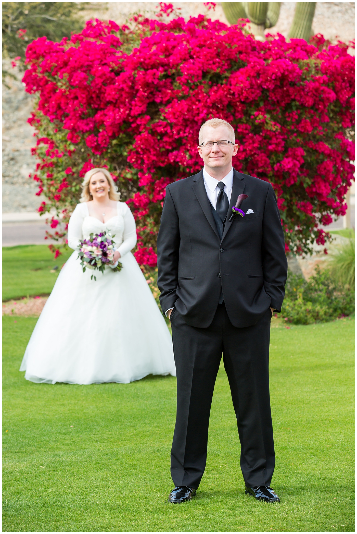 blonde bride in long sleeve wedding dress with purple and white flower bouquet and groom in black suit with purple calla lilly boutonniere first look on wedding day