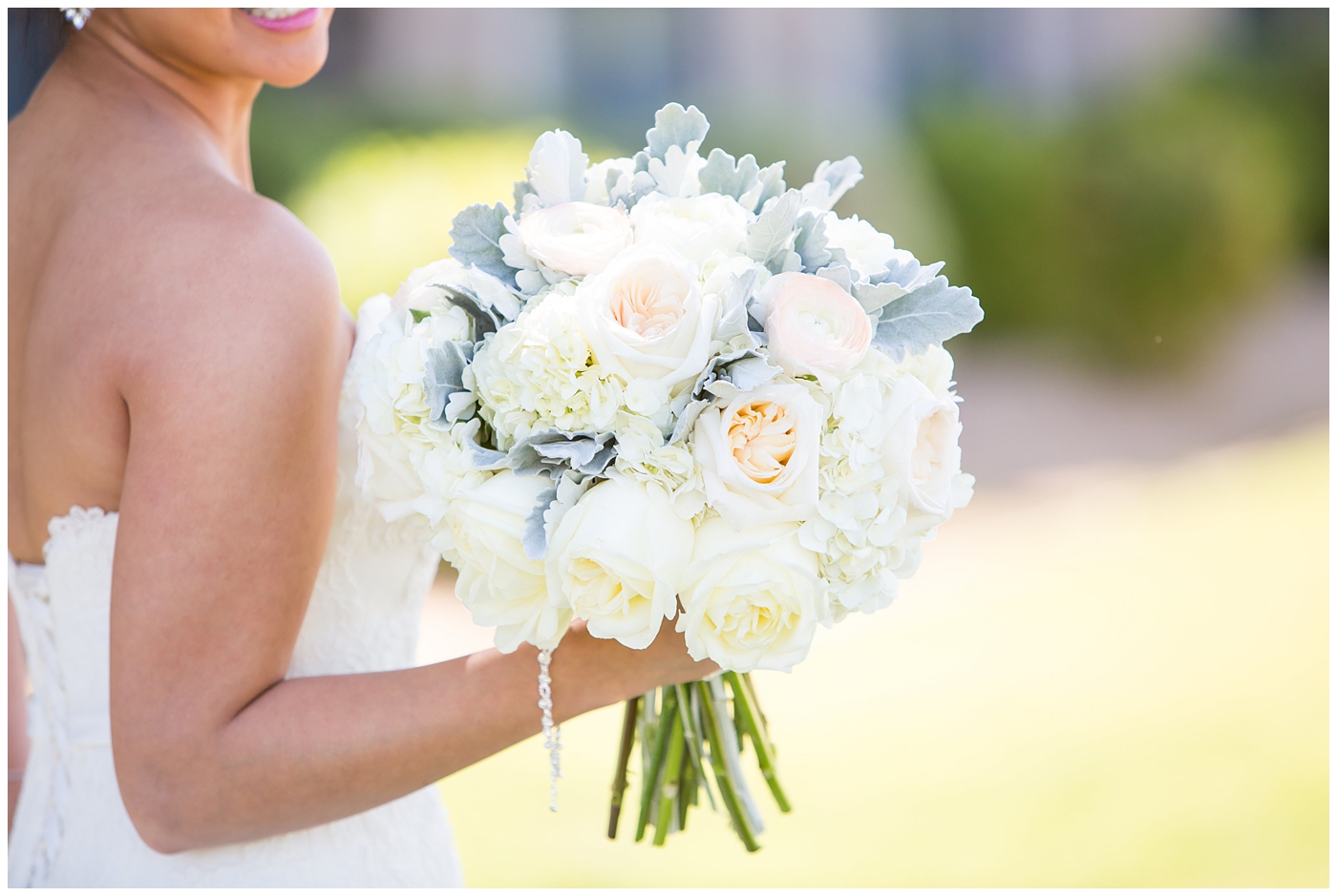 bride's wedding bouquet with soft white and pink roses, peonies, hydrangeas and greenery 