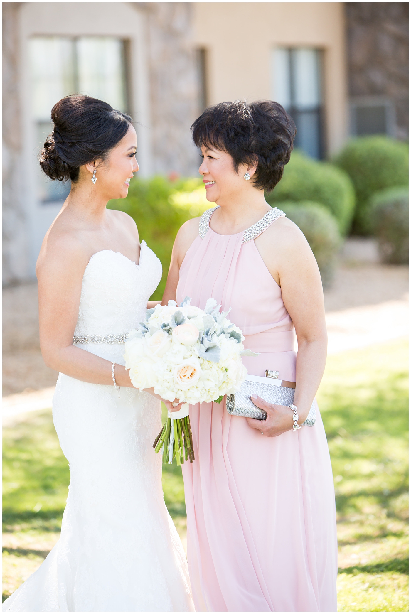 Bride in strapless maggie sorrento dress with soft white and pink roses, peonies, hydrangeas and greenery bouquet with mom in pink dress bridal portrait on wedding day