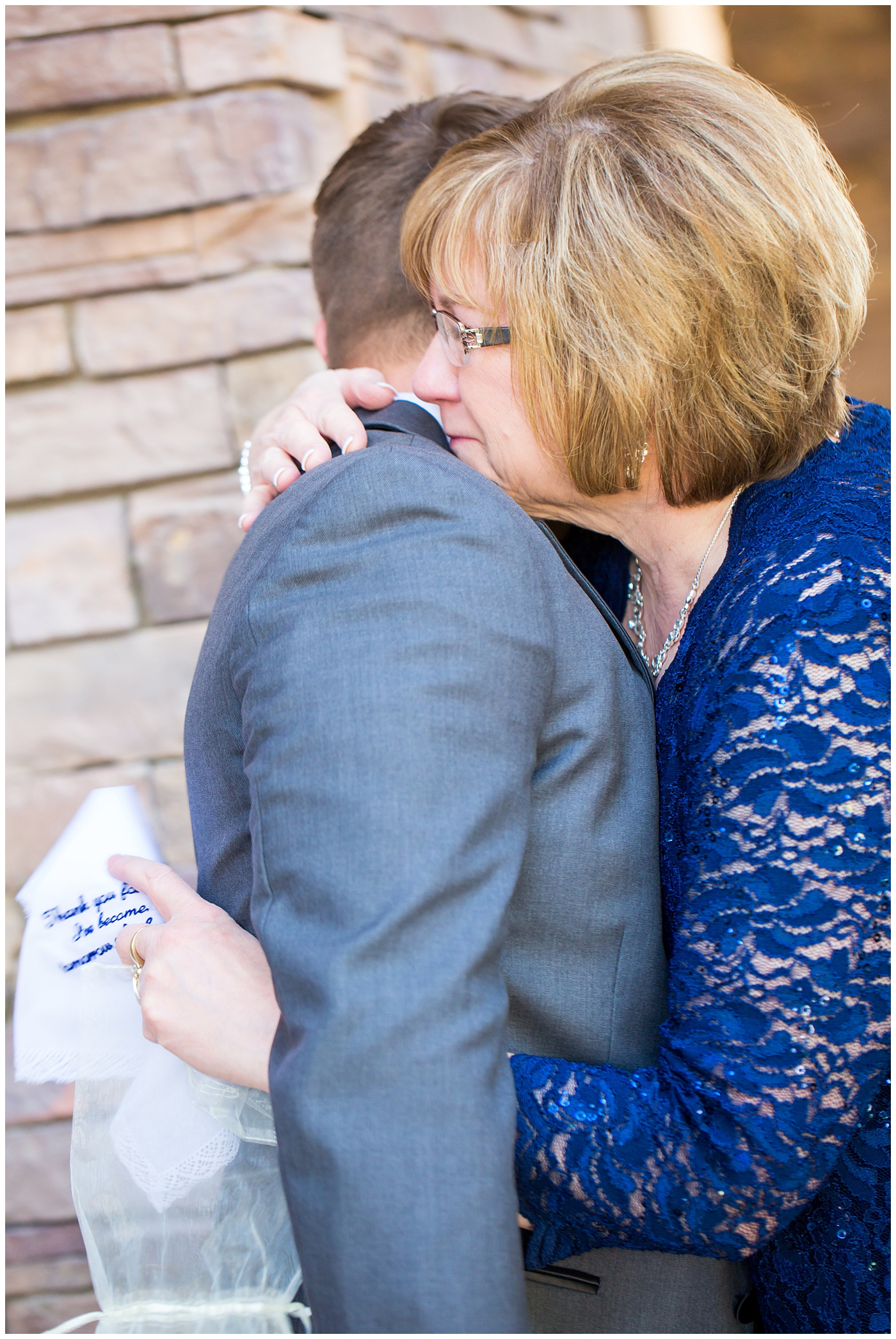 groom's mother in blue lace dress after giving custom handkerchief wedding gift