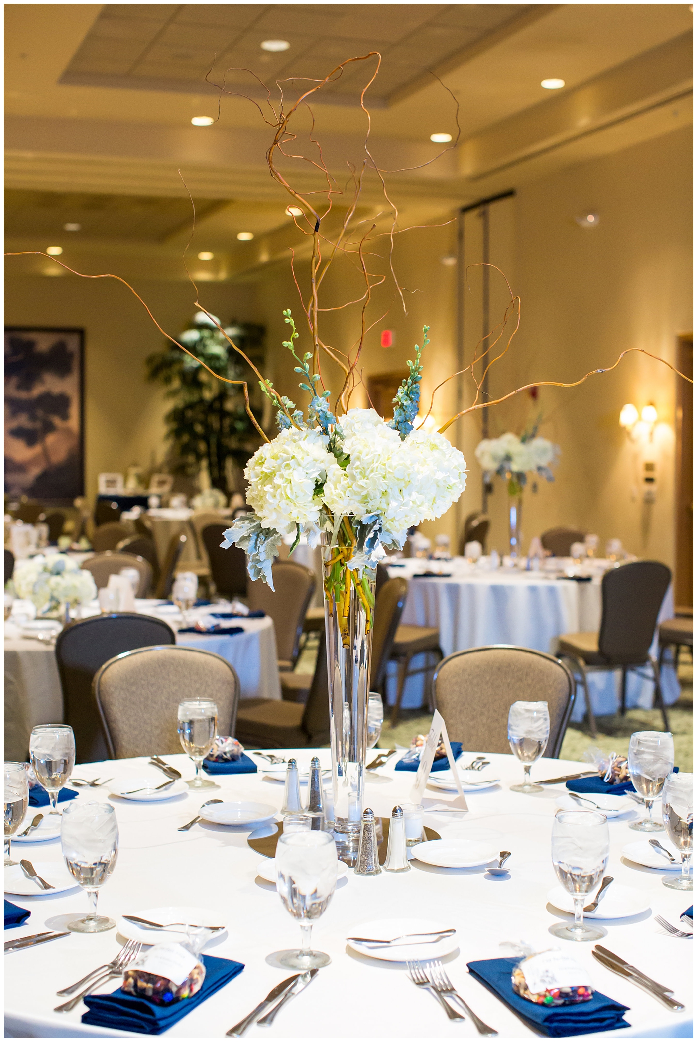 tall glass vase with hydrangeas white table cloths wedding ballroom reception details centerpieces