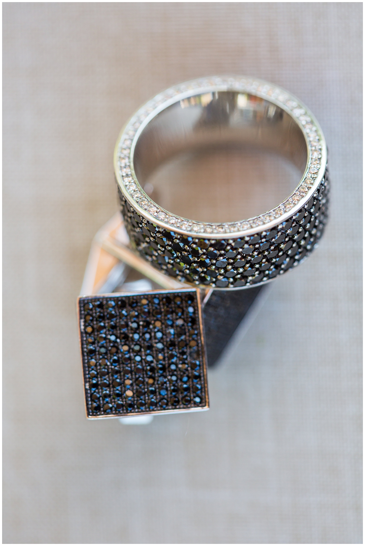 groom diamond ring with dark diamonds all around and matching cufflinks for wedding day