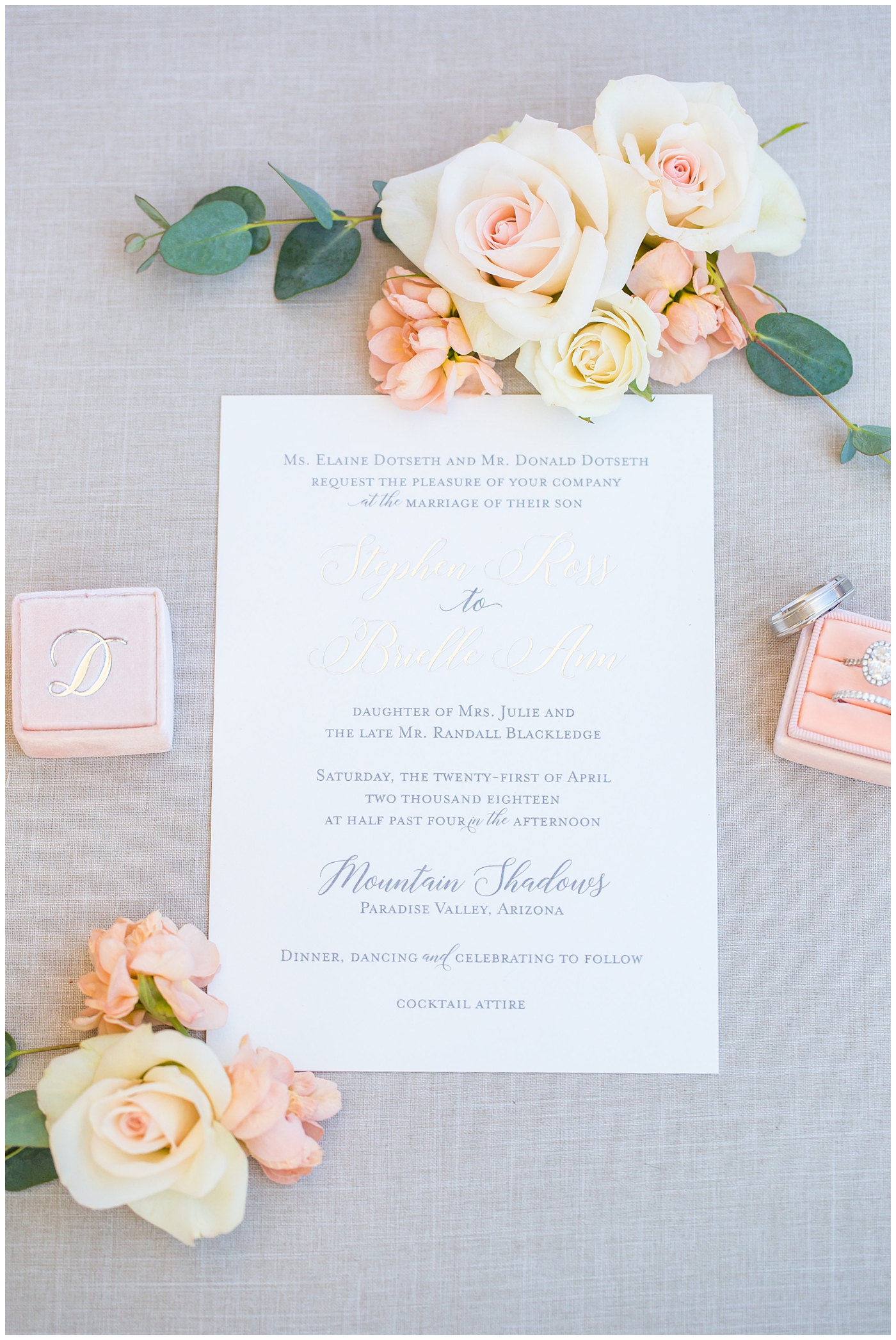 blush pink invitation with soft green watercolor suite detail flat lay with ribbon and rings wedding details