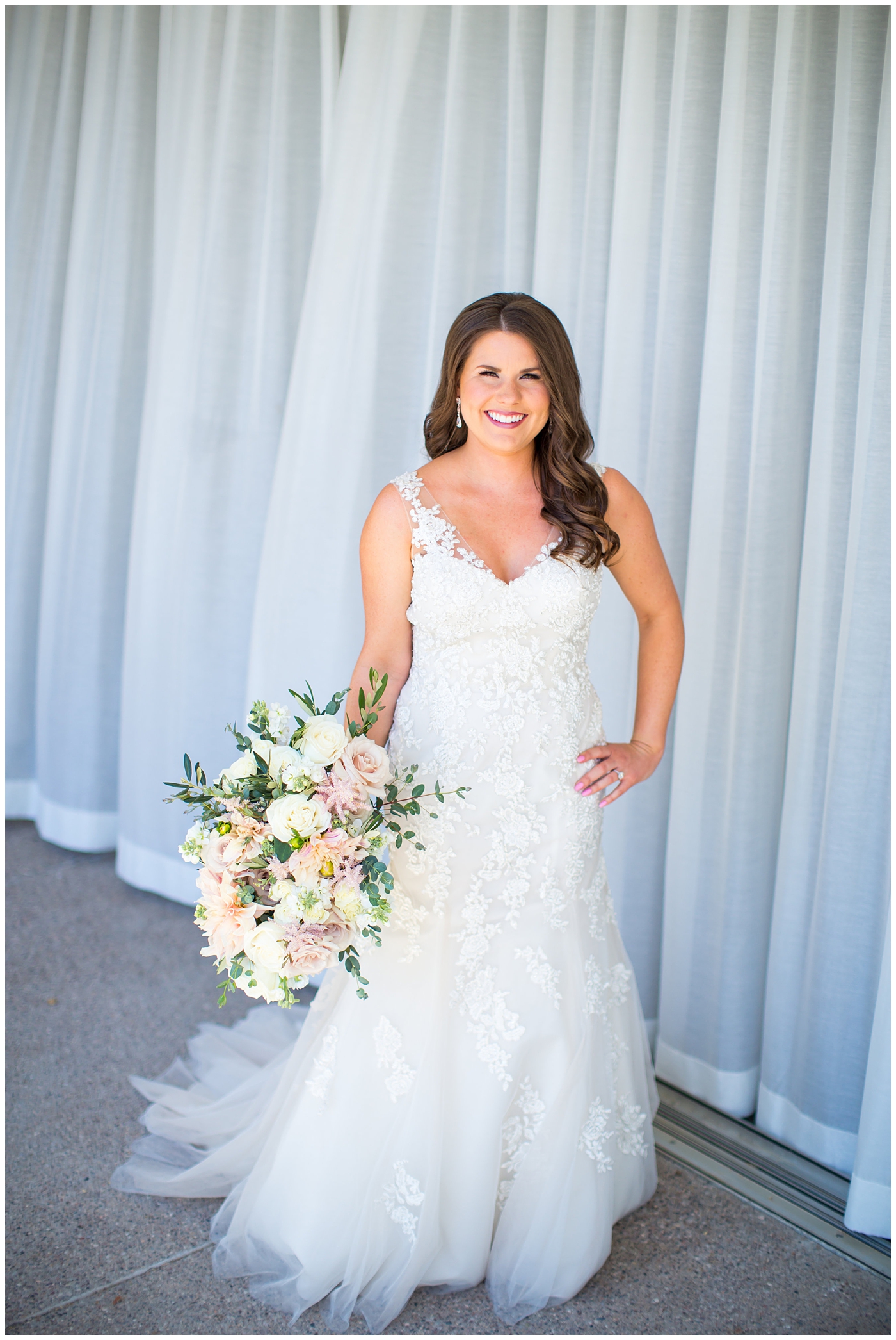 bride in wtoo watters wedding dress with lace straps with wildflower bridal bouquet with soft pink, blush, white, greenery flowers including roses, dahlias, snapdragons bridal portrait on wedding day