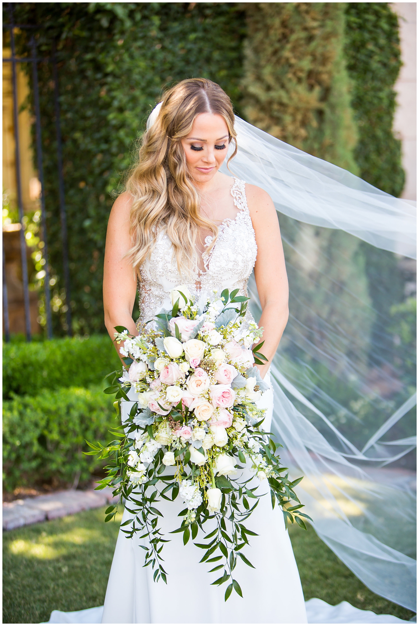 bride in lillian lottie couture strapped beaded wedding dress with organic blush, white and greenery bouquet wedding day portrait 