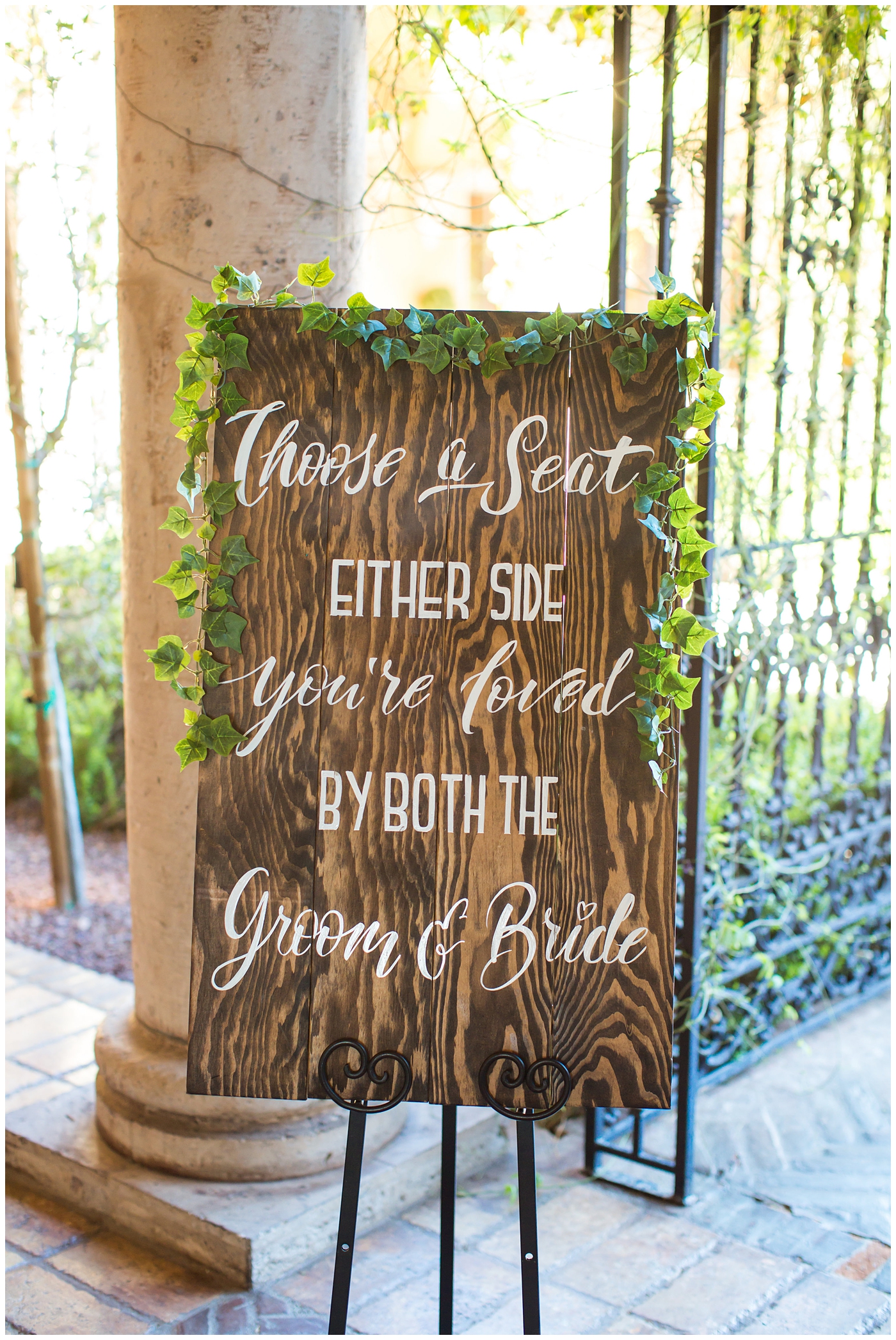 welcome wood sign with calligraphy and greenery at entry of wedding ceremony sit anywhere you would like 