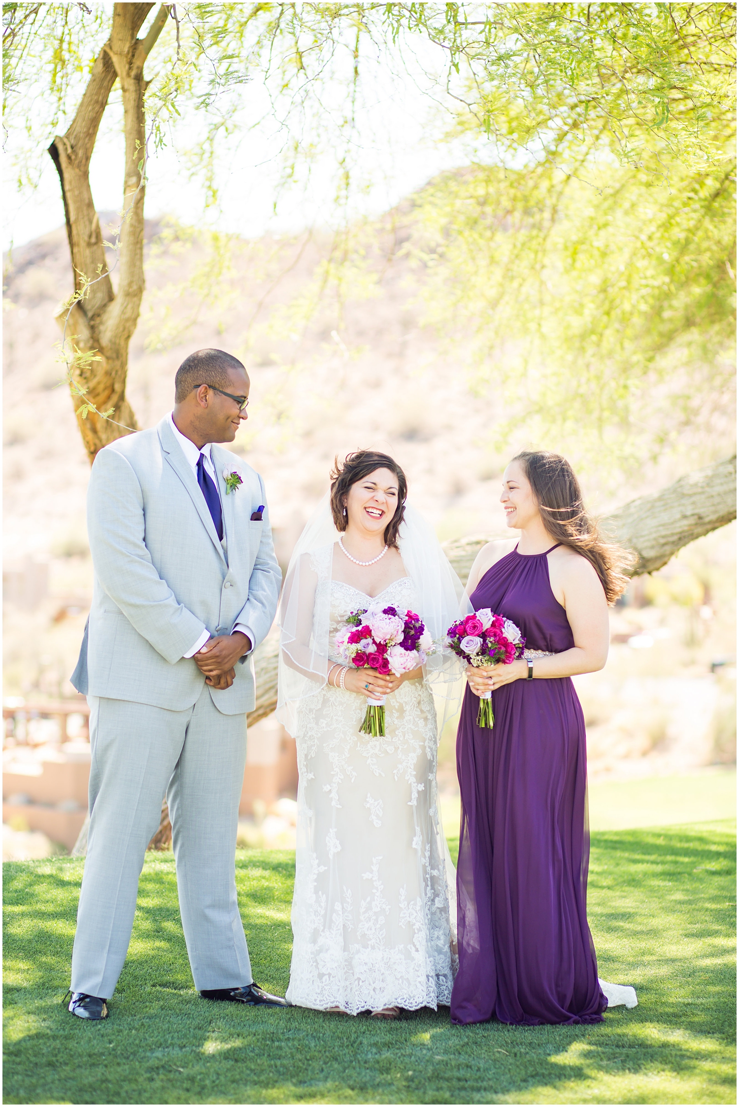 bride in strapless dress with veil and purple lavender peony and rose bouquet with bridesmaid in dark purple maxi dress and bridesman in light grey suit wedding party