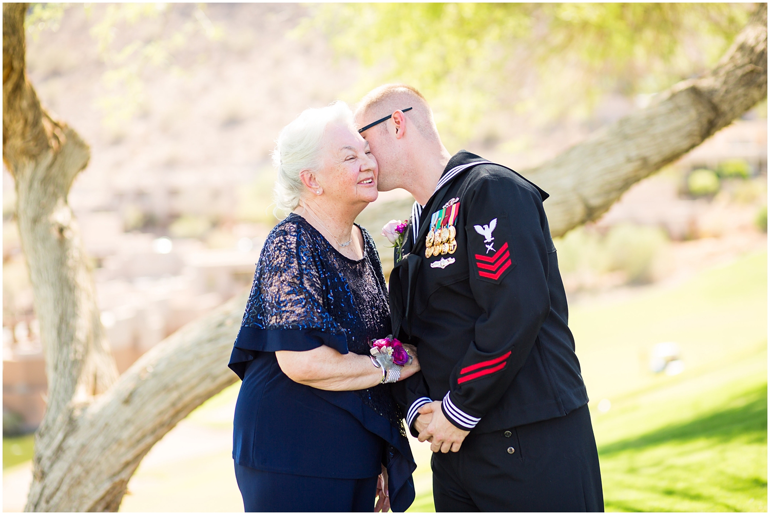 Groom in Navy dress uniform with grandma on wedding day 
